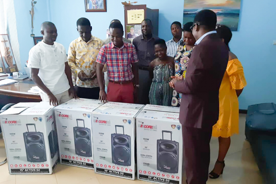 A group picture with the items been donated by the UEW PhD Student