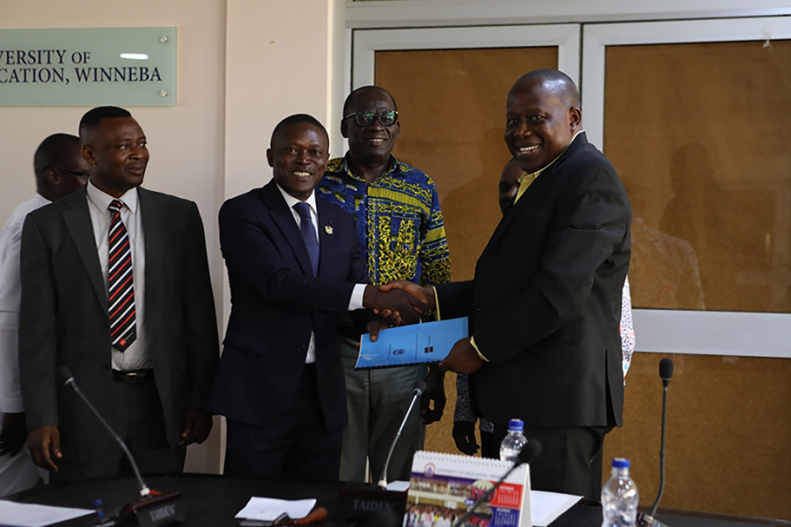 Portfolio Head, ACCA, Norman G. Wilhams in a handshake with the Vice-Chancellor, UEW, Rev. Fr. Prof. Anthony Afful-Broni (right)