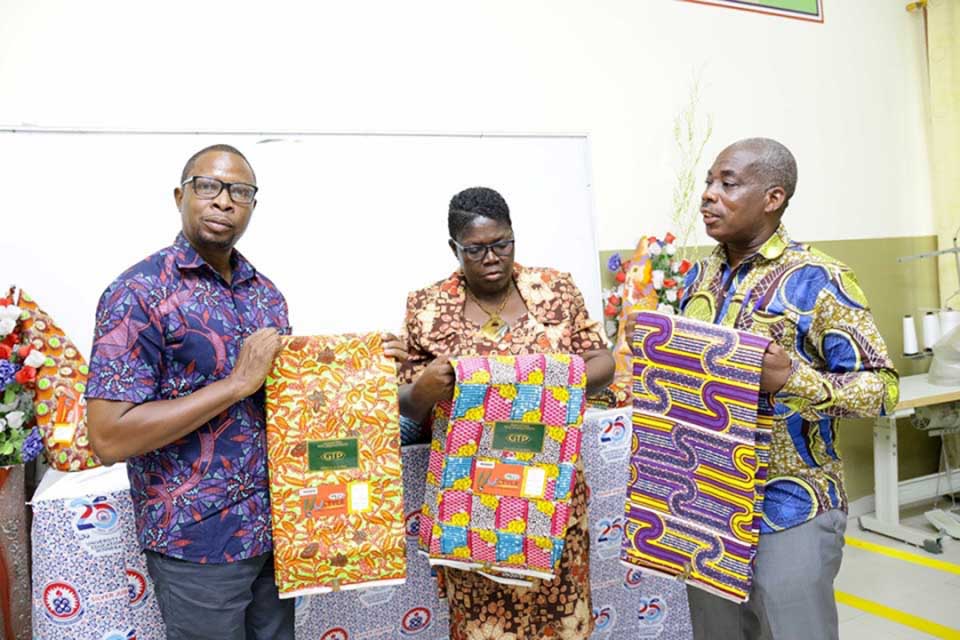(From right-left) Principal of COLTEK, Prof. Frederick K. Sarfo; Head of DFDTE, Dr. Josephine Ntiri and the Ashanti Regional Director of GTP, Mr Kwasi Baiden displaying some of the GTP Wax Prints during the ceremony