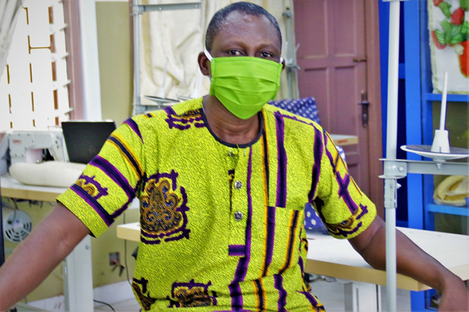Mr. Raymond Attah of the University Relations Department displays one of COLTEK Masks in style