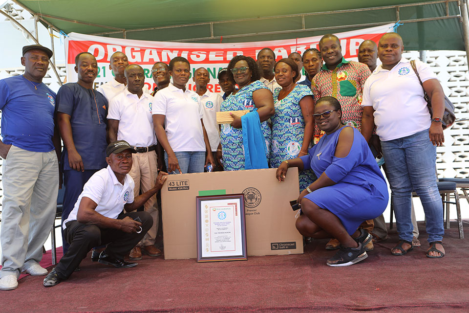 Some members of TEWU-UEW in a group pose with Ms. Ackon after the ceremony