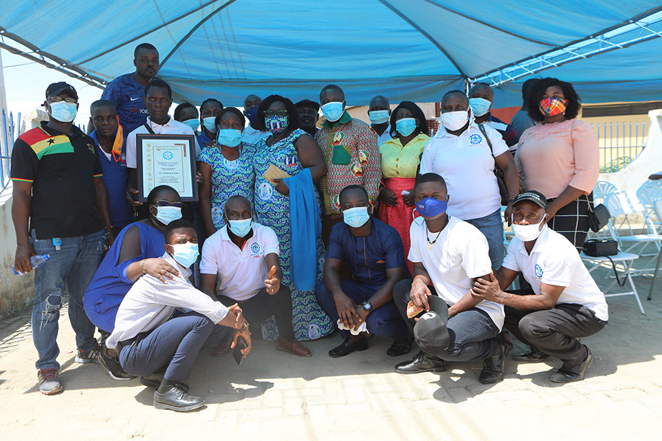 Some members of TEWU-UEW in a group pose with Ms. Ackon after the ceremony