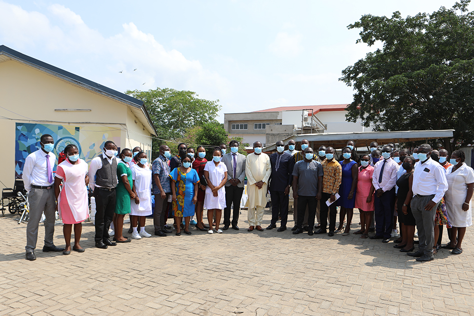 UEW management, Hospital staff and representatives of REACT Humanitarian Network in a group pose after the presentation