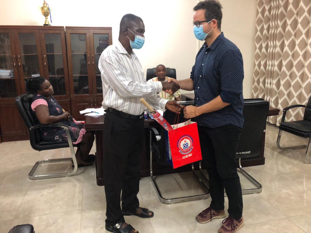 Mr. Alexander Essah (left) presenting UEW souvenirs to a member of the research team