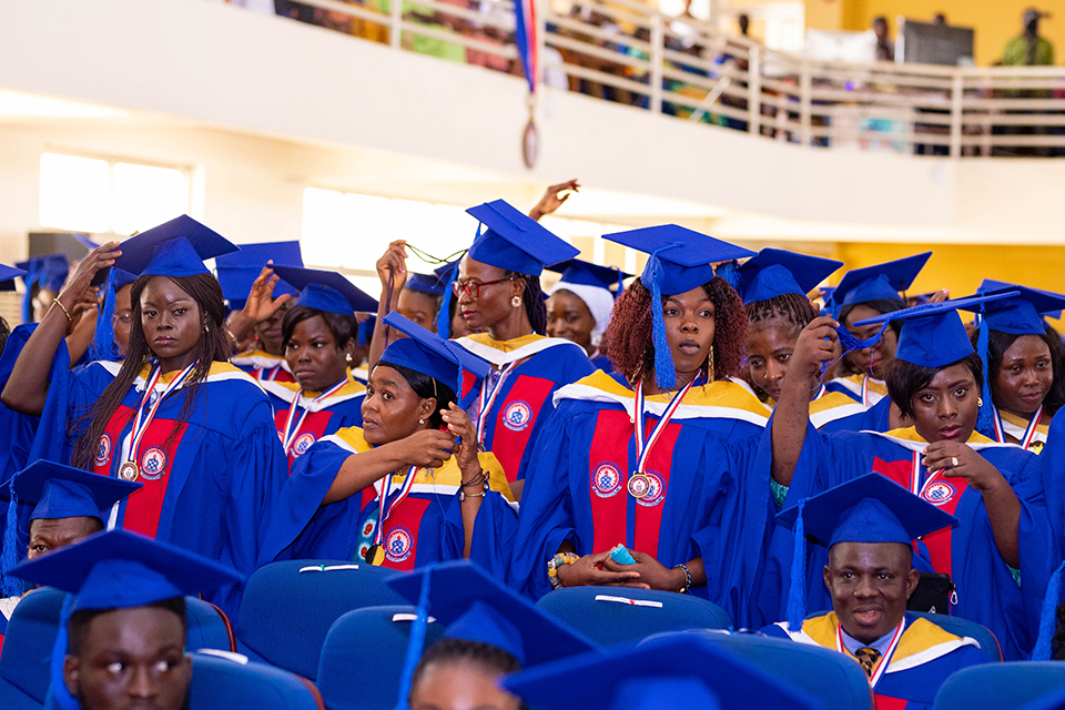 A shot of graduates moving their tussles from right to left