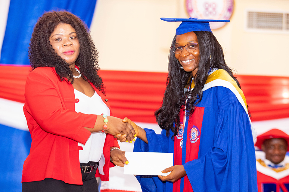 Ms. Sarah Arhinful receiving her prize from the Chief Executive Officer of the UEW Cooperative Credit Union, Mrs. Christiana Kilson