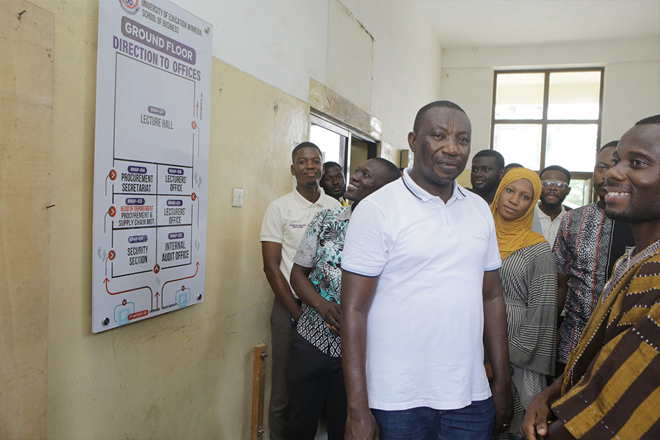 SoB staff admiring the directional post at the ground floor 
