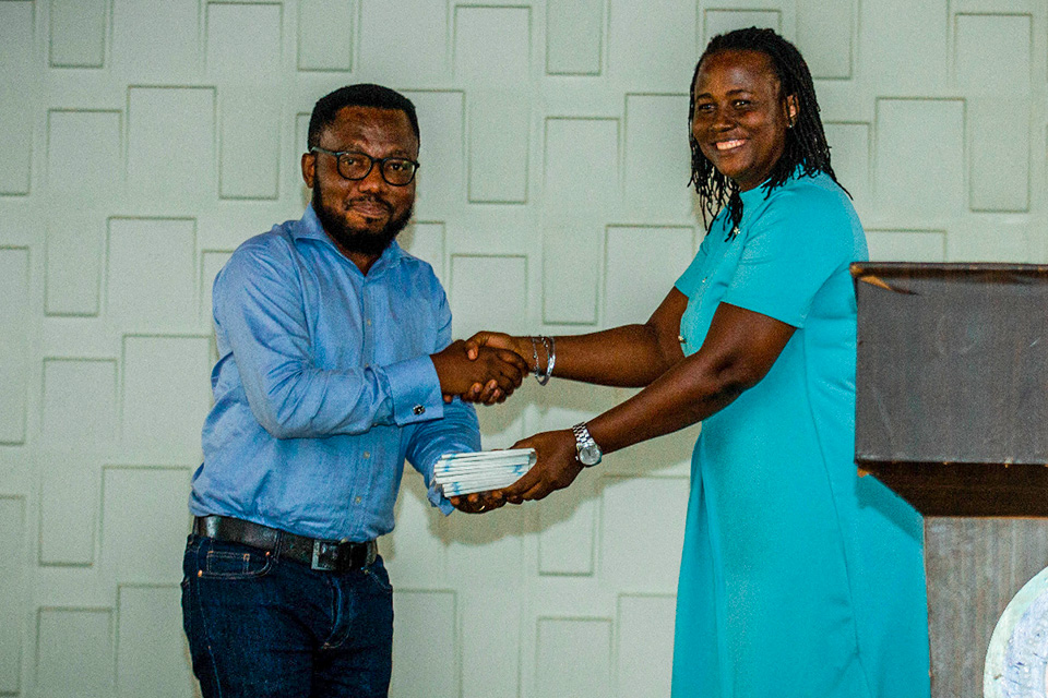 Mr. David O. Yarboi-Tetteh, Central Regional Chairman of the GJA (left), presenting copies of the GJA Constitution to Dr Gifty Appiah-Adjei
