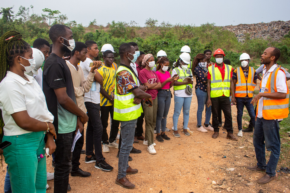 Site engineer taking students through waste management processing 