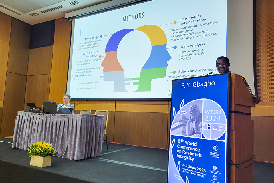 Dr. Fred Yao Gbagbo (right) engaging the audience with a thought-provoking presentation at the conference