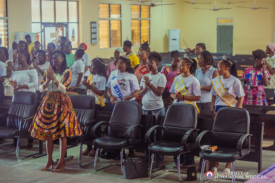 Attendees cheer with a standing ovation