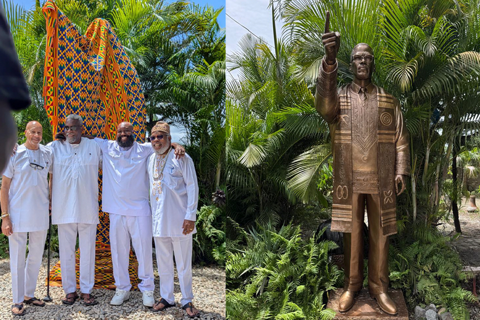 An image depicting representatives of the Malcolm X Liberation Institute alongside the ten-foot statue of Malcolm X