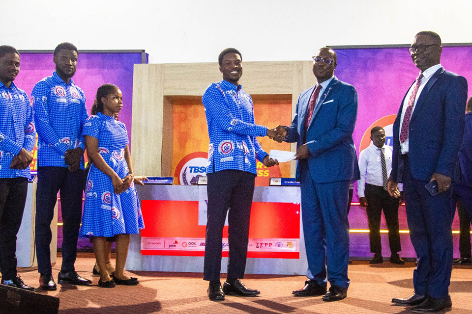 A member of the UEW quartet receiving a prize on behalf of the team
