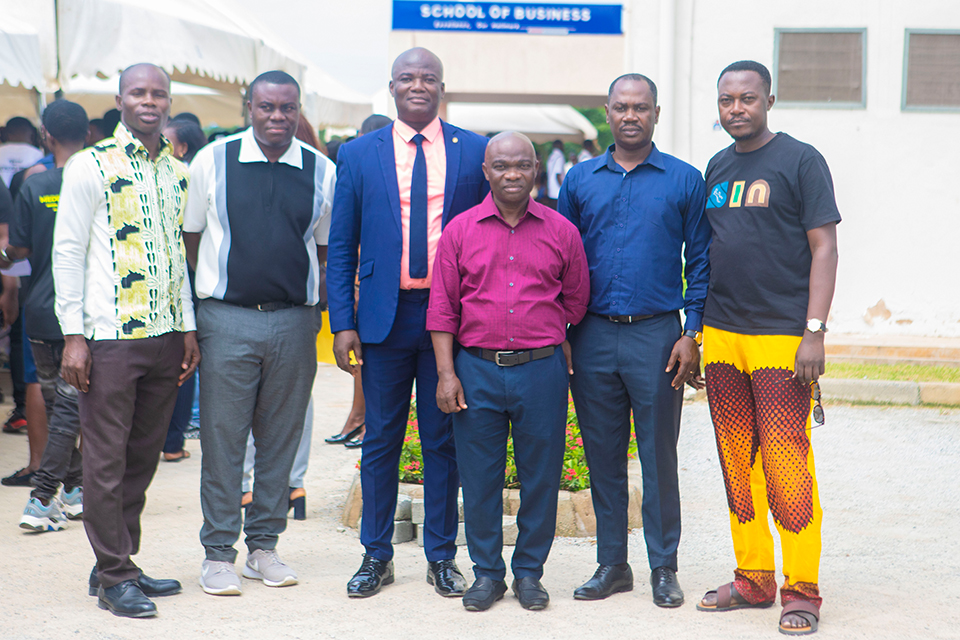 Rev. Samuel Affran (wearing a blue suit) in a group photograph with faculty members