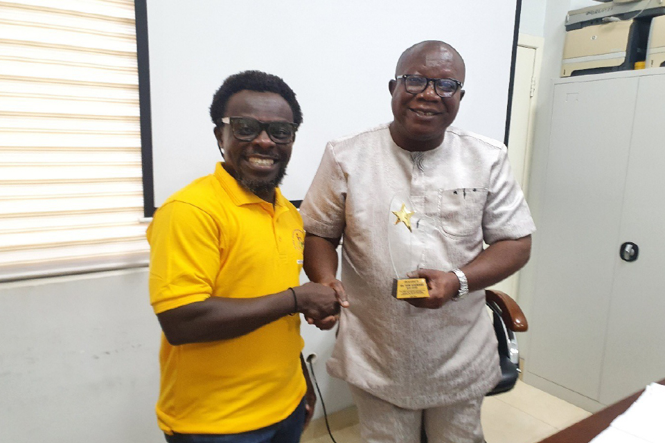 Prof. Ghanney congratulating Dr. Yaw Asamoah on receiving the award for Best Participant during the Quality Assurance Conference, in Accra.