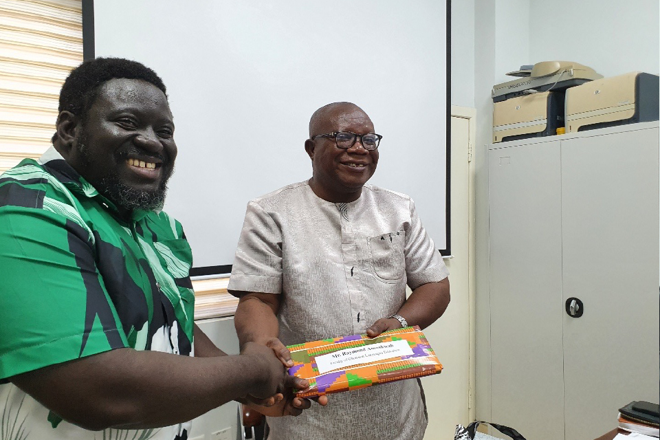 Prof. Ghanney presenting a token of appreciation to Mr. Raymond Amoakwah, FQAO for Faculty of Ghanaian Languages Education