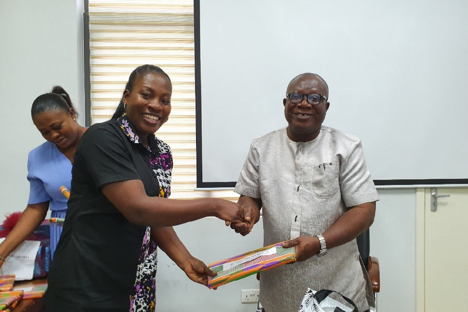 Prof. Ghanney presenting a token of appreciation to Dr. Gifty Nana Yaa Rockson, FQAO for School of Education and Life-Long Learning