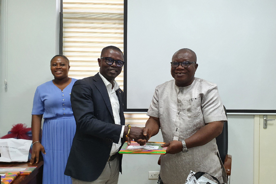 Prof. Ghanney presenting a token of appreciation to Dr. Stephen Twumasi Annan, FQAO for Faculty of Science Education