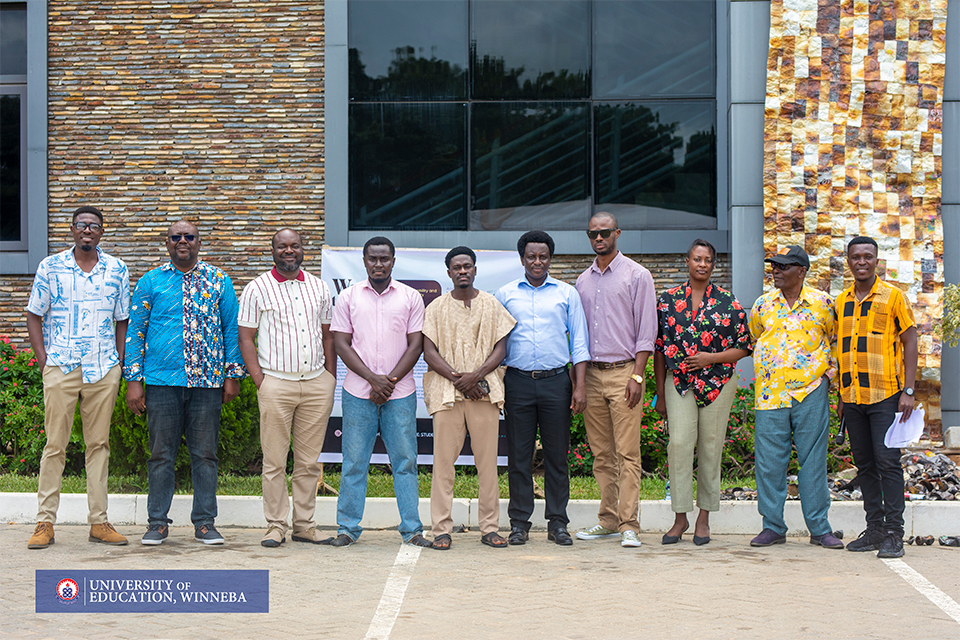 A group photo of faculty members and artists taken after the event