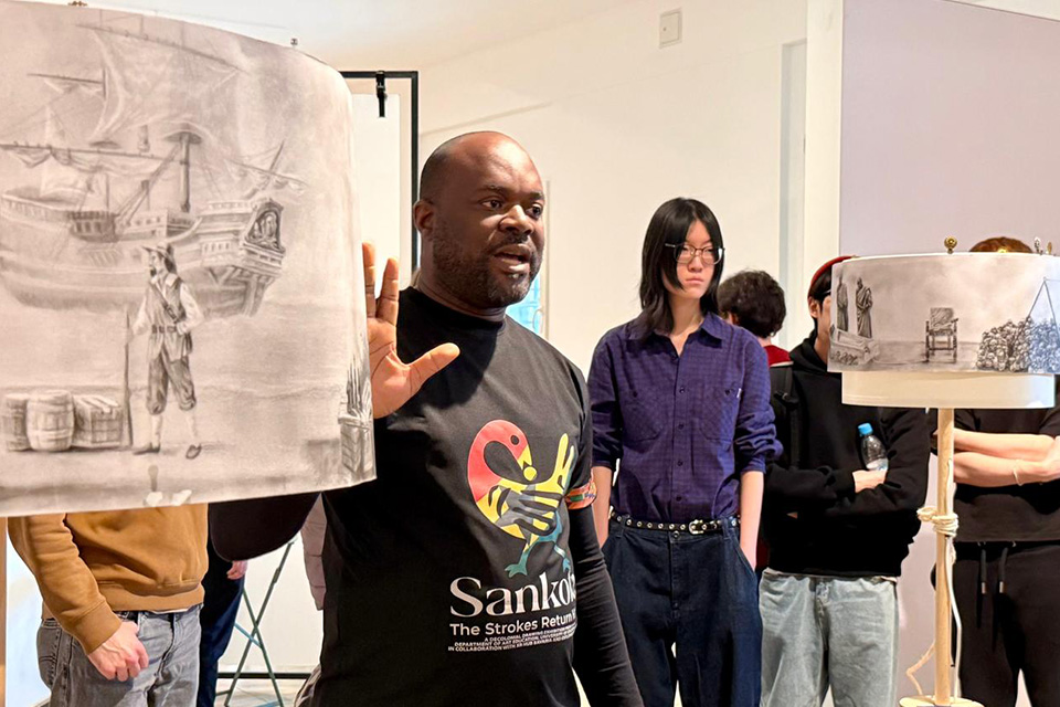 Mr. Ebenezer Kow Abraham (left) explaining the concept behind one of the artworks