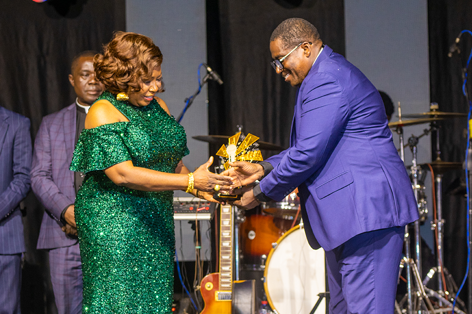 Apostle Daniel Nii Tetteh Tackie (right) presenting a commemorative plaque to the honouree